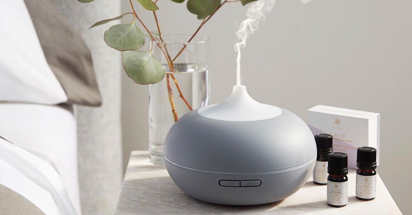 Diffuser on a side table spreading the essence of essential oils.
