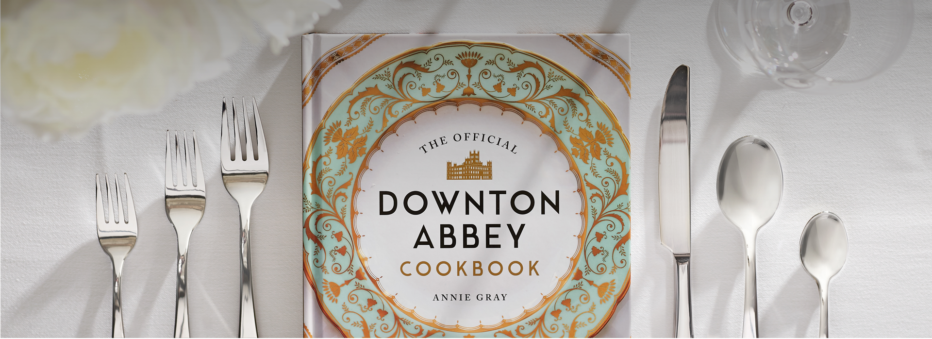 Photo of table setting with Downton Abbey Cookbook placed where the plate should be