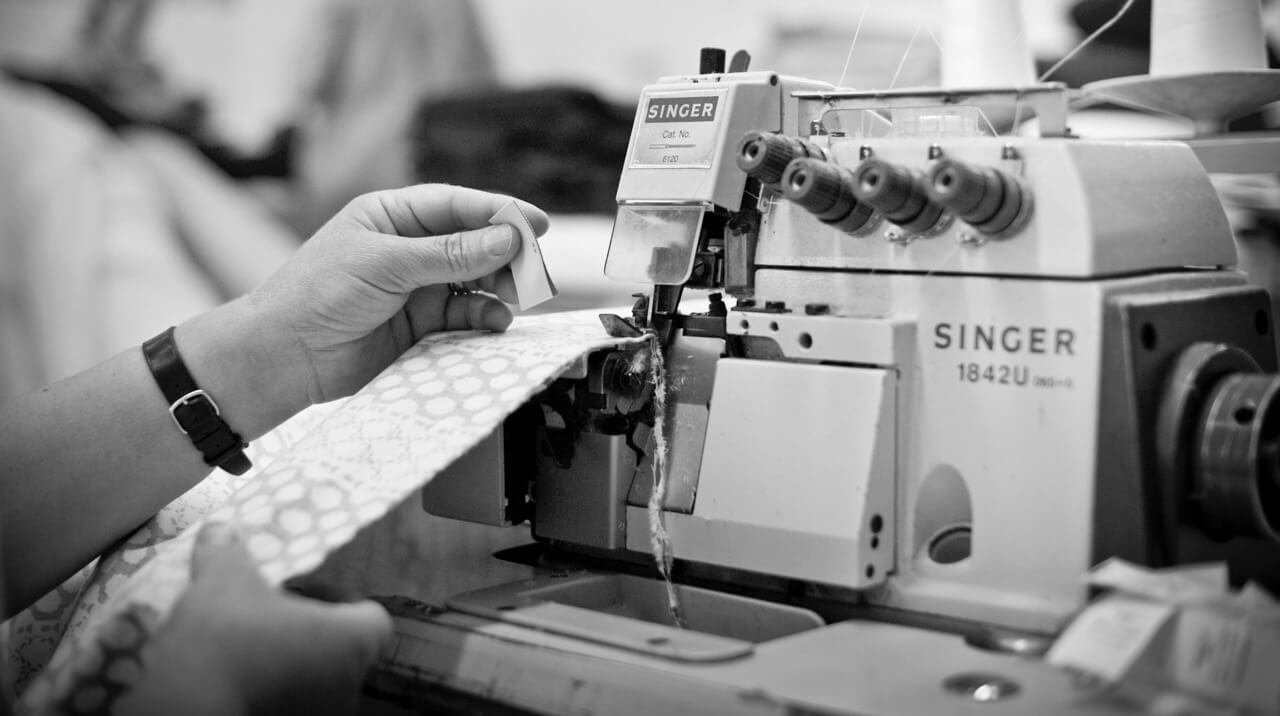 A seamstress using a sewing machine.