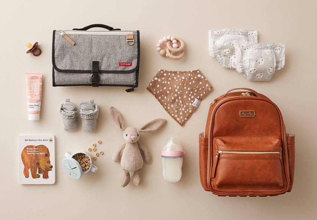 Indigobaby must-haves featuring baby bags, cloth diapers, baby toys, pacifier, books, and other accessories.