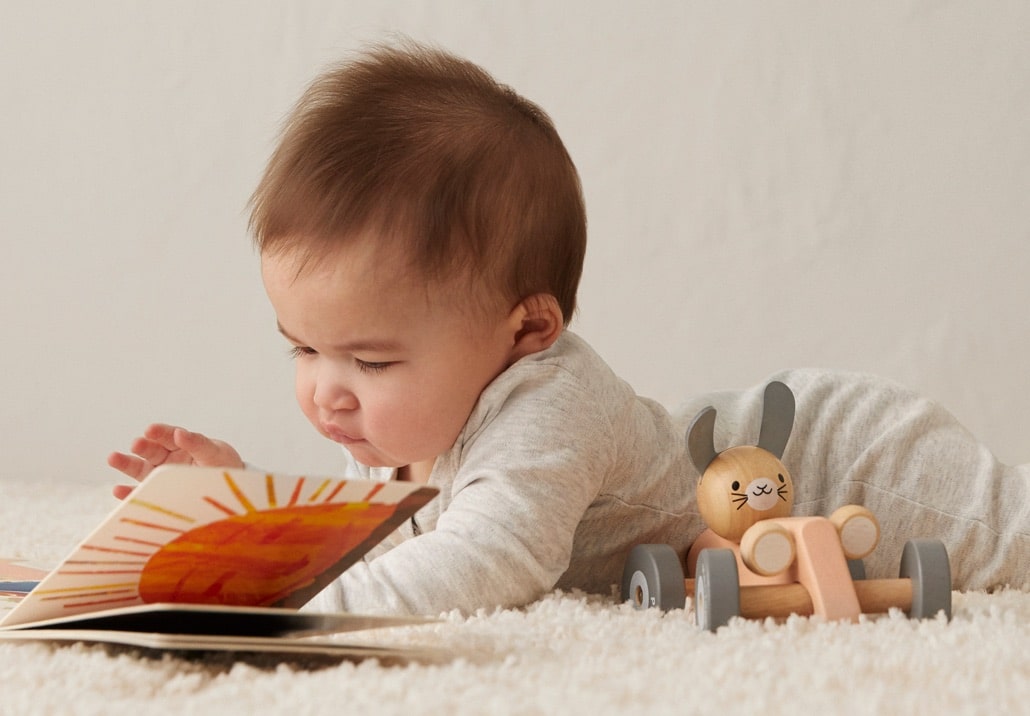 Baby reading a children's book.