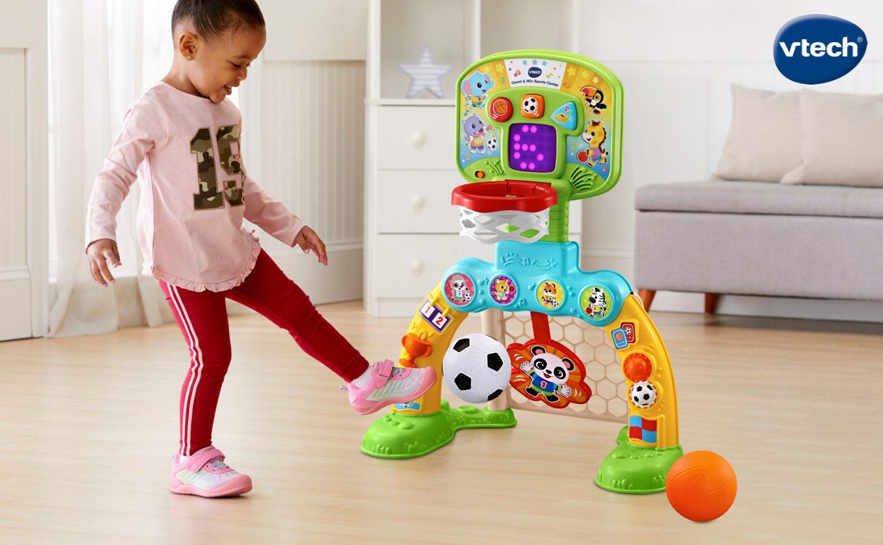 A girl playing with a VTech® soccer game.