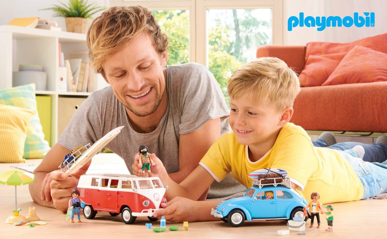 A father and son playing with Playmobil® toys.