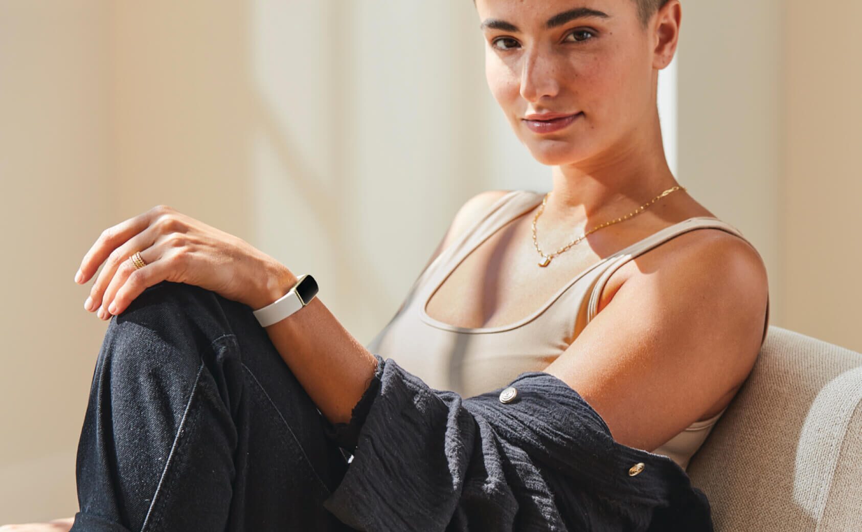 Model casually posed with a Fitbit Luxe on her wrist