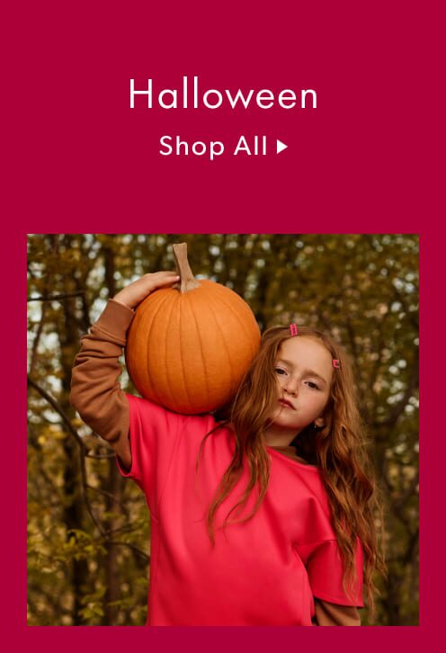 A girl holding a pumpkin.