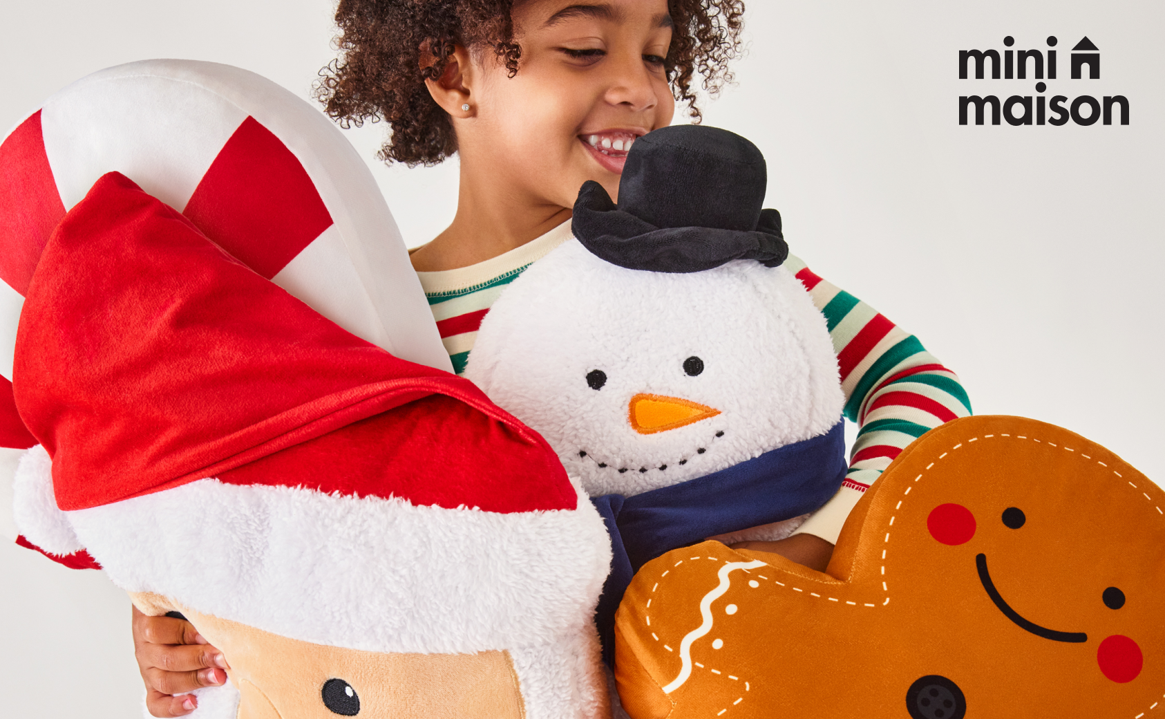 A child with Christmas themed stuffed animals