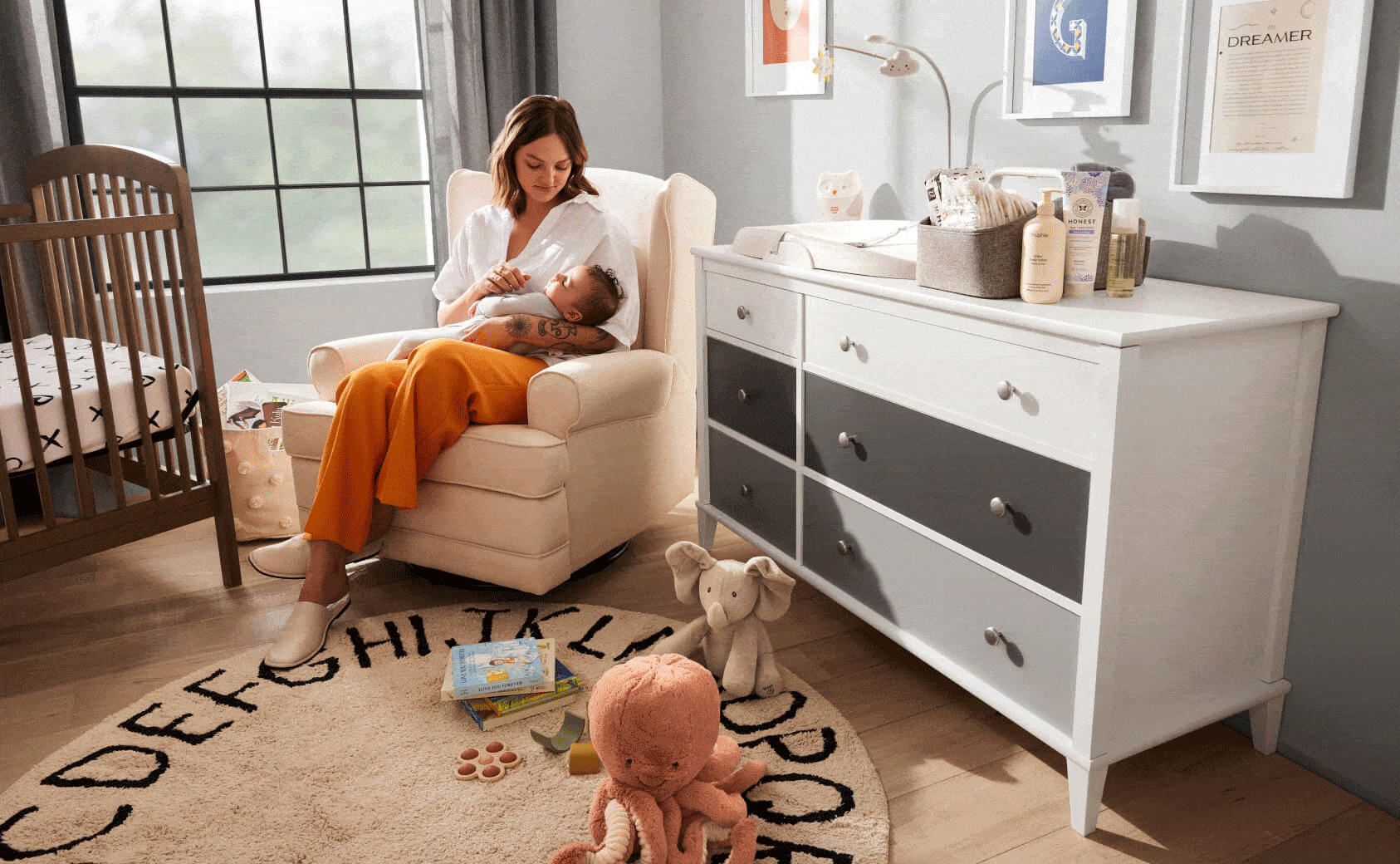 Mom and baby sitting in a chair in a nursery