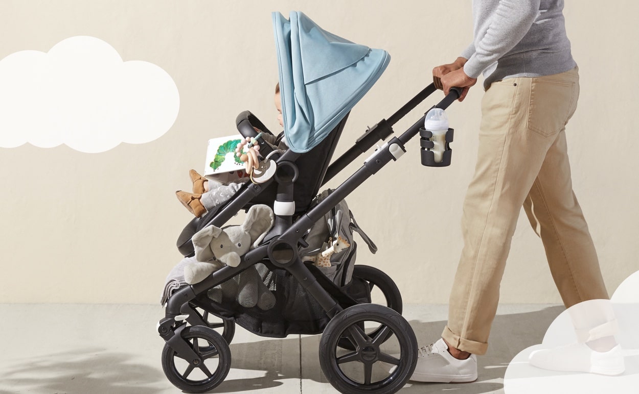 A parent pushing their baby in a stroller.