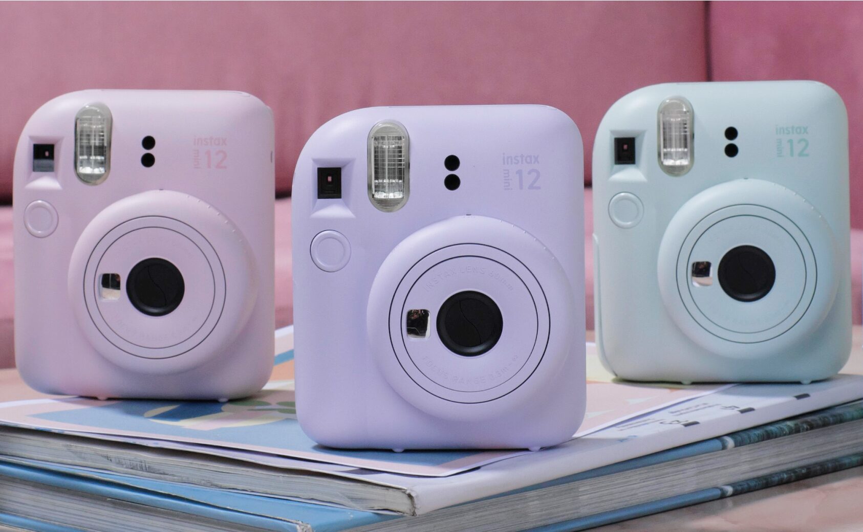 INSTAX Mini 12 cameras in pink, purple and green.