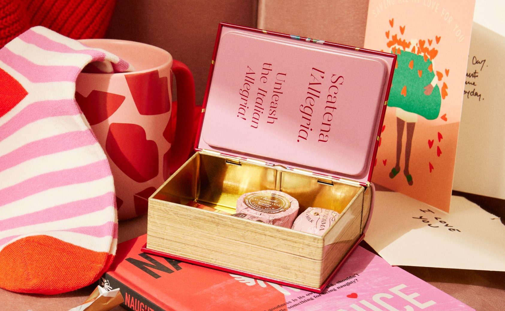 A selection of Valentine's Day Gifts, including a mug, socks and chocolates.