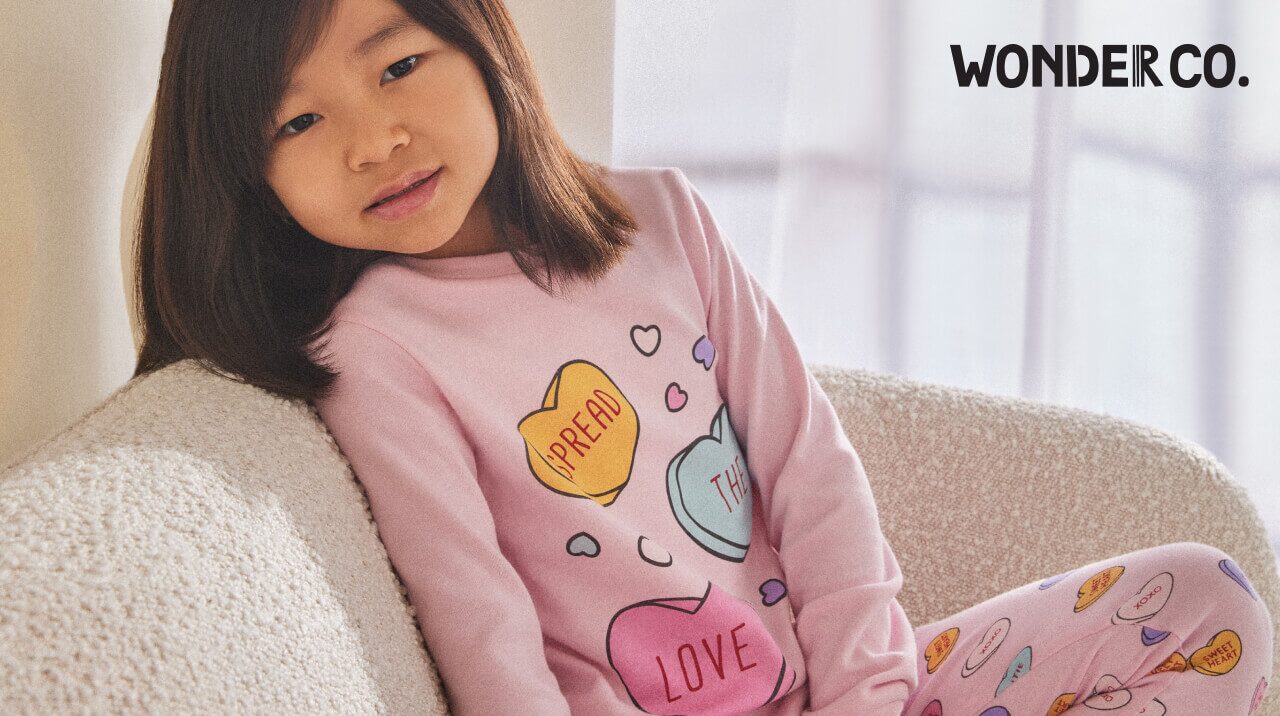 Child in Wonder Co. candy hearts pajama set.
