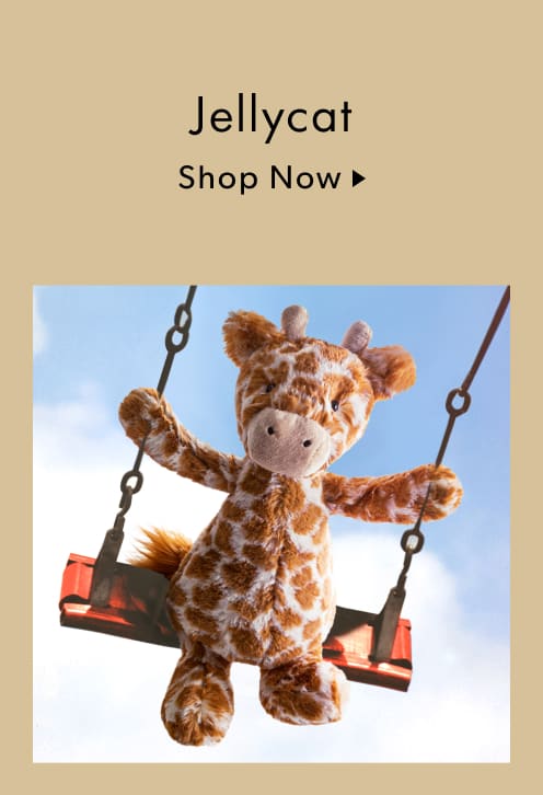 Jellycat - a jellycat giraffe sitting on a swing