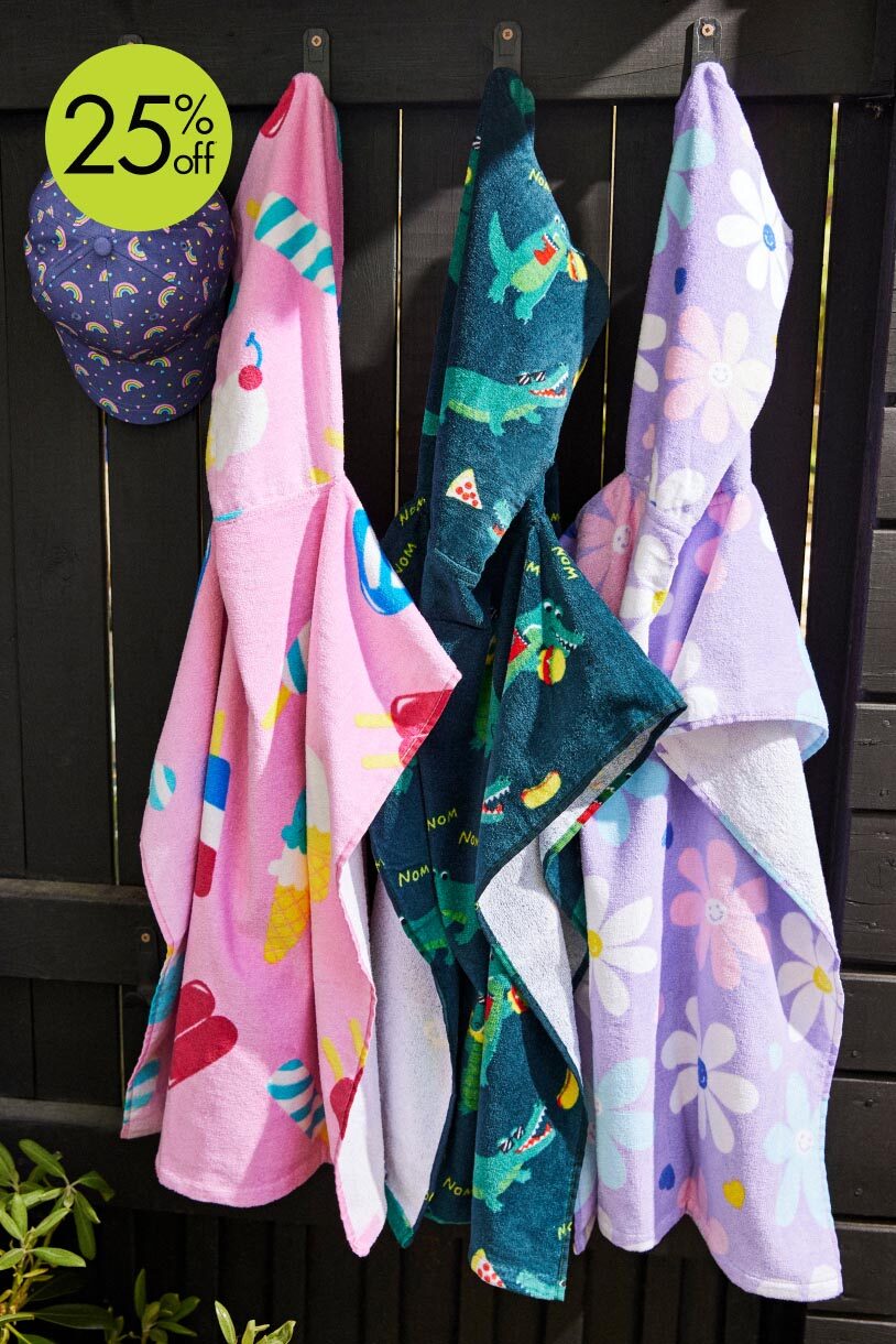 Towel ponchos for kids in different prints including daisy, popsicle, and alligator